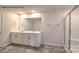 Modern bathroom featuring a double vanity, large mirror, and glass-enclosed shower at 580 N Sparkleberry St, Chester, SC 29706