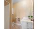 Vintage bathroom features shower, linoleum flooring, and floral wallpaper at 714 S 8Th St, Bessemer City, NC 28016