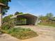 Metal carport providing covered parking, surrounded by mature landscaping at 714 S 8Th St, Bessemer City, NC 28016