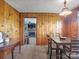 Cozy dining area features wood paneling, classic light fixture, and view of the living room fireplace at 714 S 8Th St, Bessemer City, NC 28016