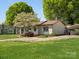 Charming single-story home with mature landscaping and a covered parking area at 714 S 8Th St, Bessemer City, NC 28016