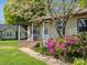 Inviting front porch with seating, colorful landscaping, and pathway to the home's entrance at 714 S 8Th St, Bessemer City, NC 28016