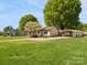 Ranch home with lush lawn, flowering tree, and convenient metal carport for covered parking at 714 S 8Th St, Bessemer City, NC 28016