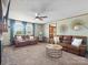 Bright living room showcasing neutral walls, fireplace, large windows, and comfortable leather sofas at 714 S 8Th St, Bessemer City, NC 28016