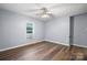 A gray bedroom featuring a ceiling fan, wood-look flooring and a window unit at 728 21St Sw St, Hickory, NC 28602