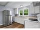 The well-lit kitchen has white appliances, lots of counter space and white cabinetry at 728 21St Sw St, Hickory, NC 28602