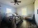 Cozy bedroom with a wrought iron bed frame, a ceiling fan, and natural light creating a comfortable retreat at 835 Leach Rd, Salisbury, NC 28146