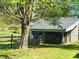 Idyllic home view featuring a large shade tree and screened porch at 835 Leach Rd, Salisbury, NC 28146