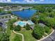 Aerial view of community pool, lake, clubhouse, and surrounding neighborhood at 861 Watling St, Fort Mill, SC 29715