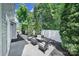 Backyard features an outdoor seating area, white fence, landscaping and mature trees at 861 Watling St, Fort Mill, SC 29715