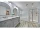 Bright bathroom with double sink vanity, large soaking tub, and glass enclosed shower at 861 Watling St, Fort Mill, SC 29715