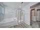 This well-lit bathroom offers a separate tub and shower, plus access to the walk-in closet at 861 Watling St, Fort Mill, SC 29715