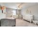 Bedroom with neutral carpet, ceiling fan, a bed, a crib, and a dresser at 861 Watling St, Fort Mill, SC 29715