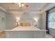 Primary bedroom boasts a tray ceiling with fan, neutral paint, and abundant natural light at 861 Watling St, Fort Mill, SC 29715