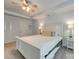 Bright bedroom features a white bed frame, tray ceiling with ceiling fan, and ensuite bathroom at 861 Watling St, Fort Mill, SC 29715
