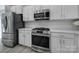 Modern kitchen featuring white cabinets, stainless steel appliances, and stylish backsplash at 861 Watling St, Fort Mill, SC 29715