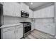 Modern kitchen featuring white cabinets, stainless steel appliances, and stylish backsplash at 861 Watling St, Fort Mill, SC 29715