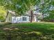 Spacious backyard with a well-maintained lawn and lush trees, offering a private outdoor space at 8718 Rittenhouse Cir, Charlotte, NC 28270