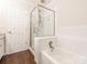 Bathroom featuring shower with glass door, white tile flooring and tub, and white door at 8718 Rittenhouse Cir, Charlotte, NC 28270