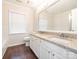 Bathroom featuring a double vanity with granite counters and modern fixtures, with window and tiled floor at 8718 Rittenhouse Cir, Charlotte, NC 28270