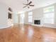 Open-concept living area with hardwood flooring, a fireplace and seamless flow to the kitchen and dining spaces at 8718 Rittenhouse Cir, Charlotte, NC 28270