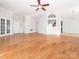 Spacious living room featuring French doors, hardwood floors, neutral paint and open to the kitchen and dining area at 8718 Rittenhouse Cir, Charlotte, NC 28270