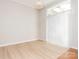 Room featuring wood-look flooring, large window with blinds, and overhead lighting at 8718 Rittenhouse Cir, Charlotte, NC 28270
