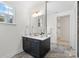 Bathroom featuring a dark vanity, modern fixtures, and beautiful mirror at 8756 Sherrills Ford Rd, Sherrills Ford, NC 28673