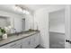 Well-lit bathroom featuring granite-topped vanity, white cabinets, and a large mirror at 8756 Sherrills Ford Rd, Sherrills Ford, NC 28673