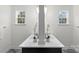 Bright bathroom with a double vanity, elegant mirrors, and modern lighting at 8756 Sherrills Ford Rd, Sherrills Ford, NC 28673