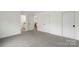 Spacious bedroom with plush neutral carpeting, access to several rooms, and bright natural light at 8756 Sherrills Ford Rd, Sherrills Ford, NC 28673