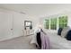 Serene bedroom with large windows and a cozy seating area. Modern decor and natural light at 8756 Sherrills Ford Rd, Sherrills Ford, NC 28673