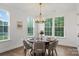 Elegant dining room with a round table, modern chandelier, and large windows overlooking the greenery at 8756 Sherrills Ford Rd, Sherrills Ford, NC 28673