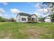 View of the home's back exterior featuring siding, windows, a covered porch, and a spacious yard at 8756 Sherrills Ford Rd, Sherrills Ford, NC 28673