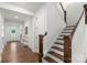Hallway showcasing wood floors, stairs, and white trim at 8756 Sherrills Ford Rd, Sherrills Ford, NC 28673