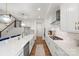 Open kitchen featuring white cabinetry, stainless steel appliances, a breakfast bar, and hardwood floors at 8756 Sherrills Ford Rd, Sherrills Ford, NC 28673