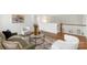 Open-concept living room showcasing hardwood floors, modern seating, and an open staircase at 8756 Sherrills Ford Rd, Sherrills Ford, NC 28673