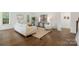 Cozy living room featuring hardwood floors, neutral decor, and comfortable seating at 8756 Sherrills Ford Rd, Sherrills Ford, NC 28673