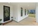 Charming porch with black front door, decorative wreath, and welcoming doormat at 8756 Sherrills Ford Rd, Sherrills Ford, NC 28673
