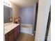 This bathroom features a vanity with sink, wood cabinets and a shower-tub with neutral walls at 9668 Walkers Glen Nw Dr, Concord, NC 28027