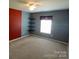 This bedroom features a window, floating shelves, carpet flooring, ceiling fan and neutral walls at 9668 Walkers Glen Nw Dr, Concord, NC 28027
