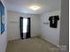 This bedroom features white walls with a window, carpet flooring and a sports theme for relaxation at 9668 Walkers Glen Nw Dr, Concord, NC 28027