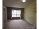 Bright bedroom featuring a window, ceiling fan and decorative shelving at 9668 Walkers Glen Nw Dr, Concord, NC 28027