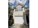 Tan townhome featuring a one car garage, black shutters and complementary landscaping at 9668 Walkers Glen Nw Dr, Concord, NC 28027