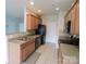 Modern kitchen with black appliances, tile backsplash and neutral countertops at 9668 Walkers Glen Nw Dr, Concord, NC 28027