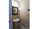 Cozy powder room with a pedestal sink, decorative mirror and tile floors at 9668 Walkers Glen Nw Dr, Concord, NC 28027