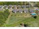 A high aerial view showcasing neighborhood homes, green spaces, and a community pool at 9867 Travertine Trl, Davidson, NC 28036