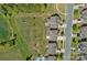 Overhead view of homes, streets, and green spaces in a suburban neighborhood at 9867 Travertine Trl, Davidson, NC 28036
