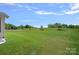 Spacious backyard with lush green grass and trees at 9867 Travertine Trl, Davidson, NC 28036