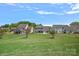 Expansive backyard with lush green grass and well-maintained landscaping in a residential neighborhood at 9867 Travertine Trl, Davidson, NC 28036